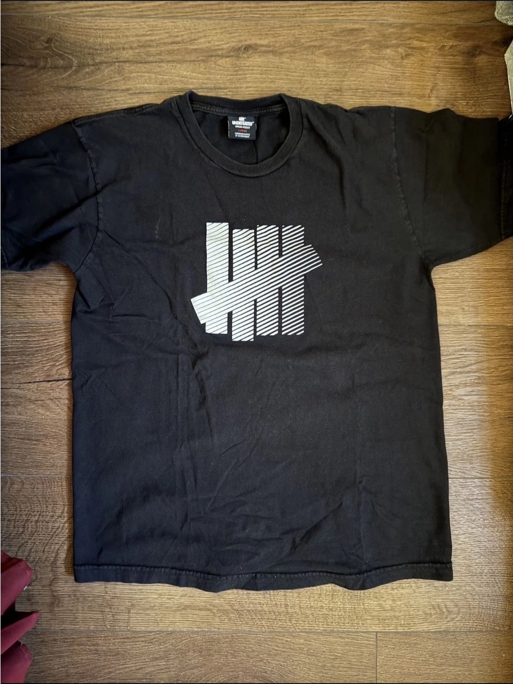 Undefeated Black Tee with White Striped Tally Logo